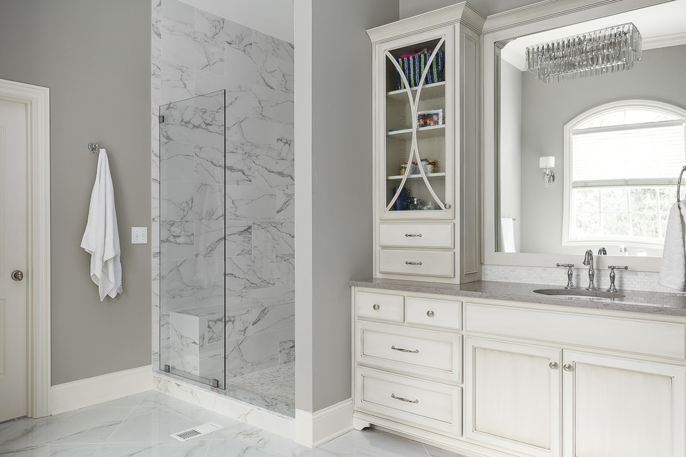 Example of a large transitional master marble floor and gray floor claw-foot bathtub design in Louisville with recessed-panel cabinets, white cabinets, gray walls and an undermount sink