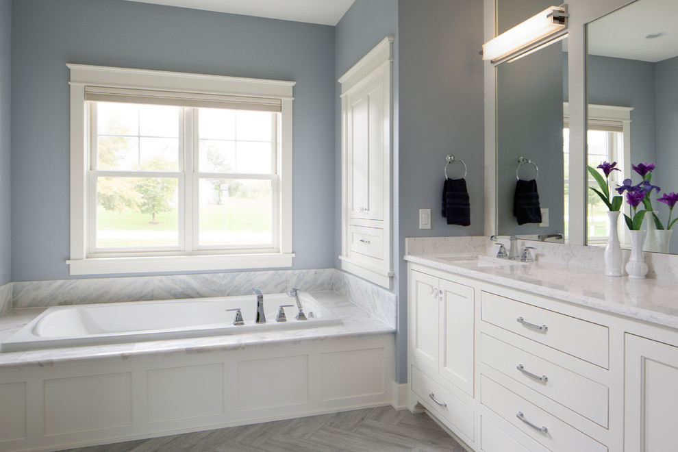 Example of a large arts and crafts master ceramic tile and gray tile ceramic tile and gray floor bathroom design in Milwaukee with flat-panel cabinets, white cabinets, blue walls, an undermount sink, granite countertops, white countertops and a hinged shower door