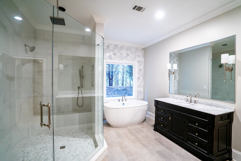 Mid-sized trendy master gray tile and porcelain tile porcelain tile and gray floor bathroom photo in Atlanta with furniture-like cabinets, black cabinets, a one-piece toilet, gray walls, an undermount sink, marble countertops, a hinged shower door and white countertops