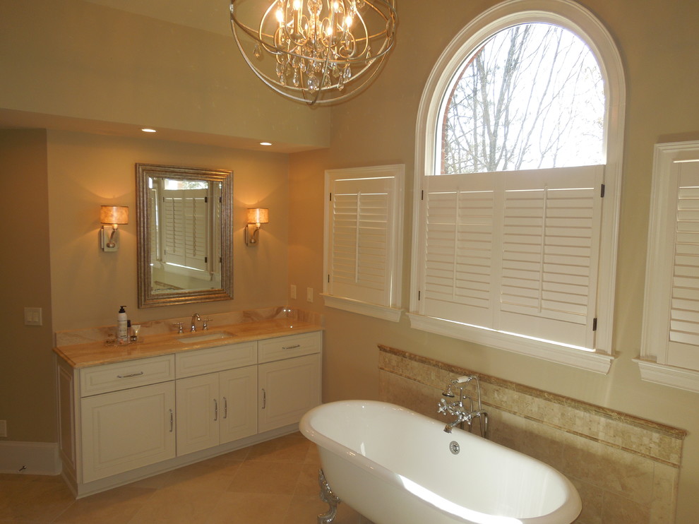 Inspiration for a large classic ensuite bathroom in Atlanta with shaker cabinets, beige cabinets, a claw-foot bath, a walk-in shower, a two-piece toilet, beige tiles, marble tiles, beige walls, marble flooring, a trough sink, marble worktops, beige floors and a hinged door.
