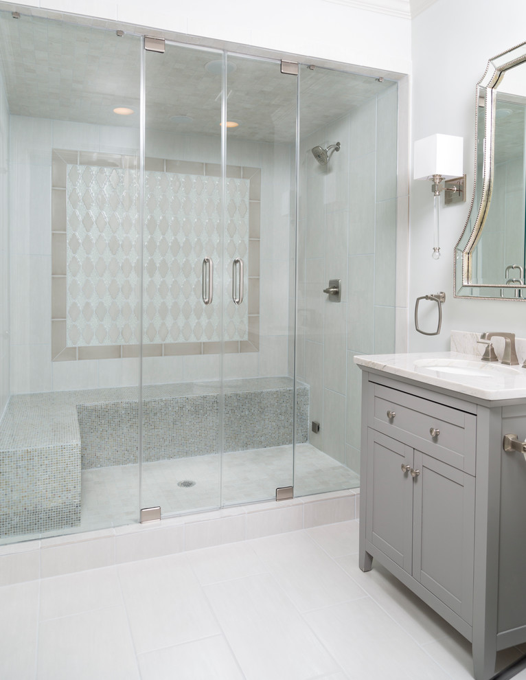 Medium sized traditional shower room bathroom in Atlanta with shaker cabinets, grey cabinets, an alcove shower, white tiles, porcelain tiles, white walls, porcelain flooring, a submerged sink, marble worktops, white floors and a hinged door.