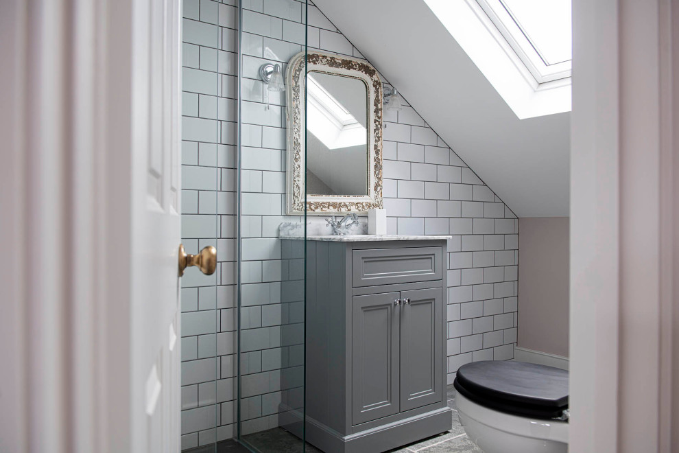 Inspiration for a classic bathroom in London with recessed-panel cabinets, grey cabinets, white tiles, metro tiles, grey floors, white worktops, a single sink and a built in vanity unit.