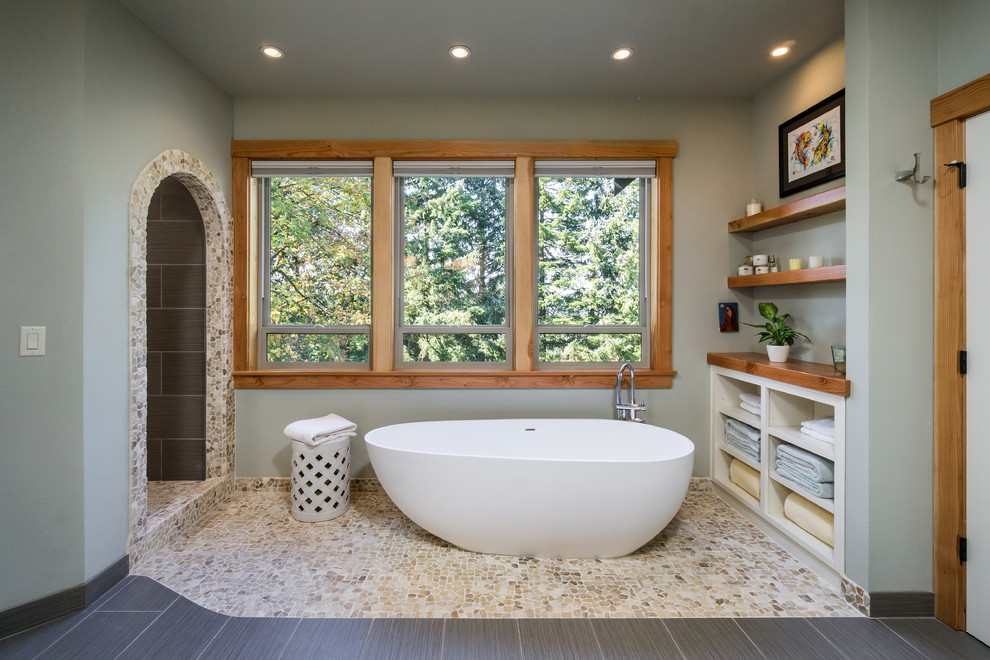 Inspiration for a rustic ensuite bathroom in Portland with white cabinets, a freestanding bath, a walk-in shower, wooden worktops, grey walls, pebble tile flooring and an open shower.