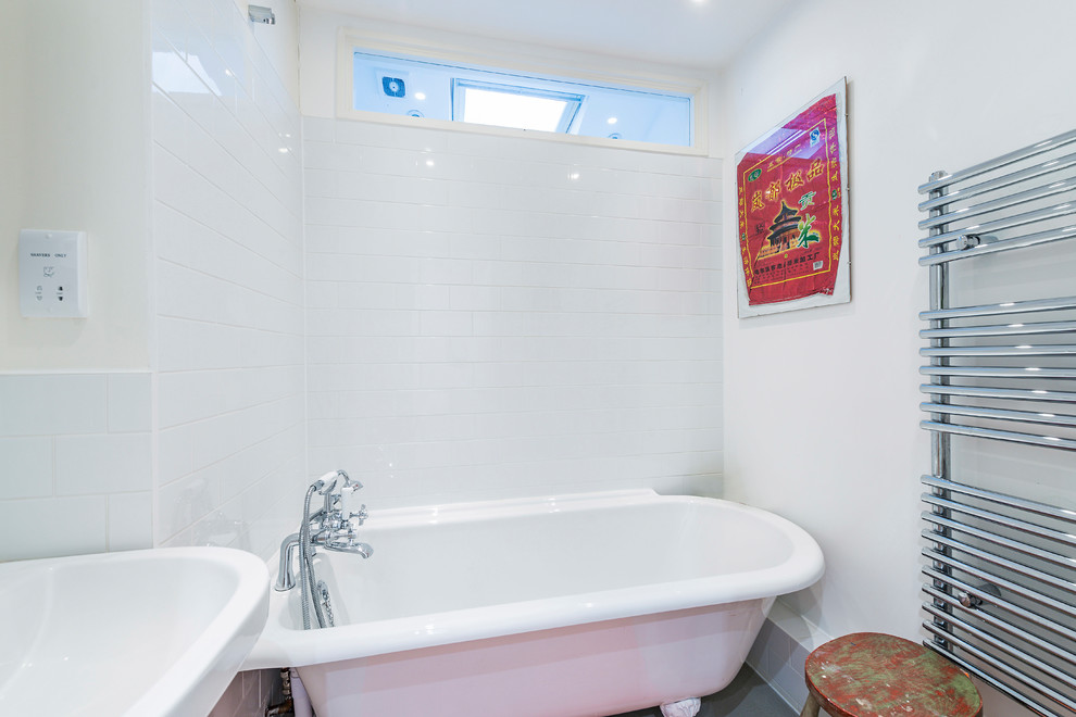 Small contemporary family bathroom in London with flat-panel cabinets, white cabinets, a claw-foot bath, a two-piece toilet, white tiles, ceramic tiles, white walls, concrete flooring, a built-in sink, wooden worktops, grey floors and white worktops.