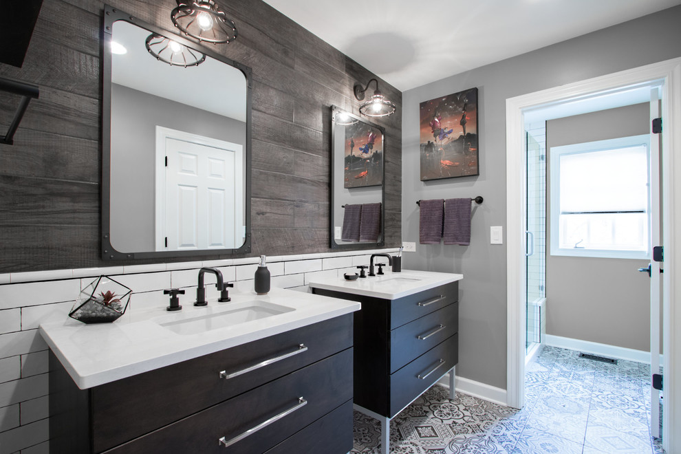 Alcove shower - mid-sized industrial kids' brown tile and porcelain tile porcelain tile and multicolored floor alcove shower idea in Chicago with furniture-like cabinets, dark wood cabinets, gray walls, an undermount sink, quartz countertops, a hinged shower door and white countertops