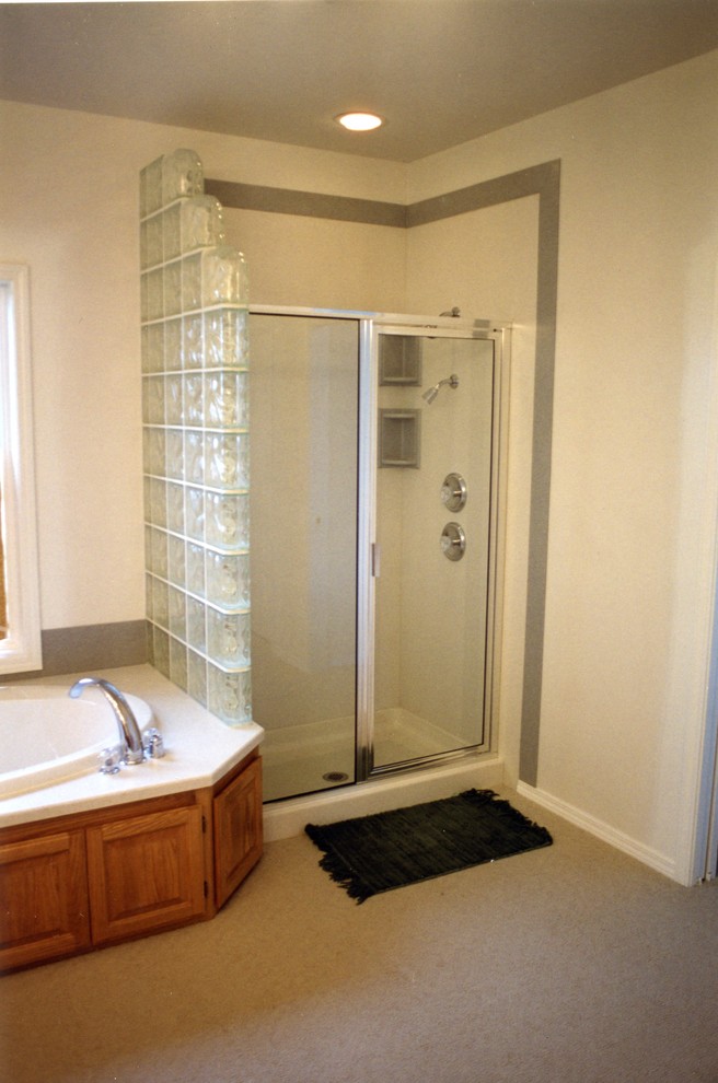This is an example of a medium sized eclectic bathroom in Seattle with solid surface worktops and a corner shower.