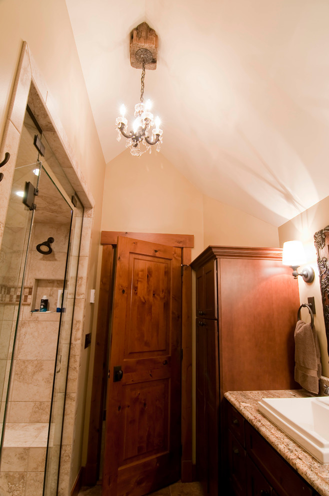 This is an example of a small rustic bathroom in Denver with a built-in sink, a double shower, medium wood cabinets, raised-panel cabinets, granite worktops, beige tiles, ceramic tiles and beige walls.