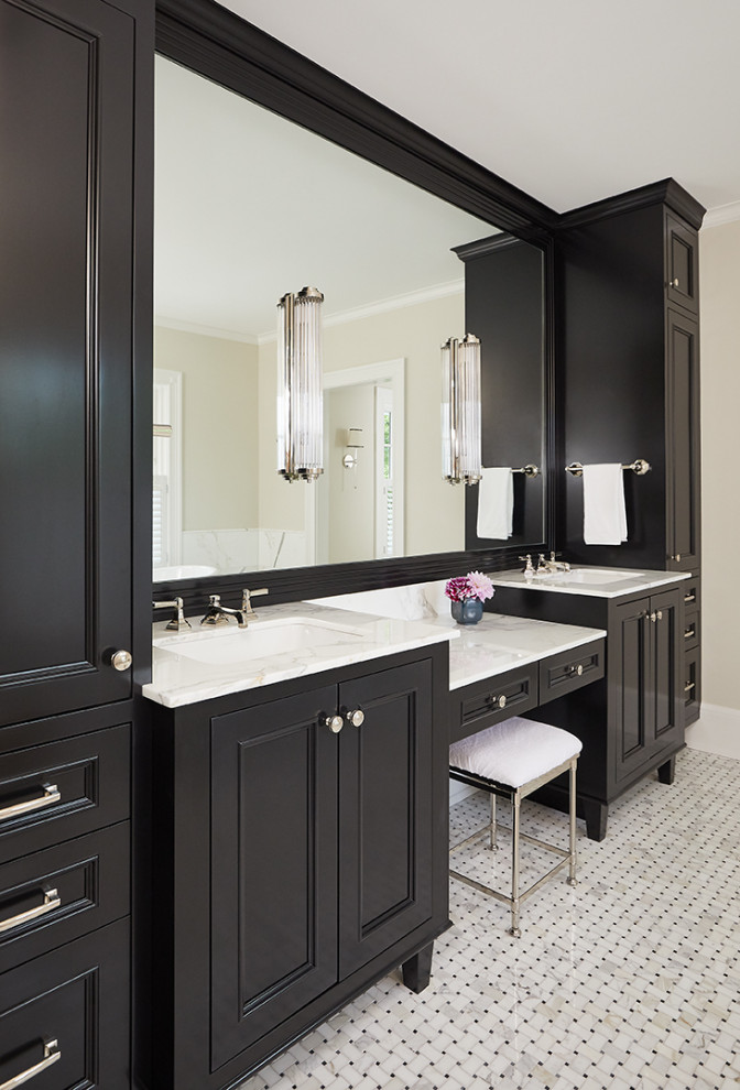This is an example of a traditional ensuite bathroom in Grand Rapids with black cabinets, beige walls, a submerged sink, multi-coloured floors, white worktops and recessed-panel cabinets.