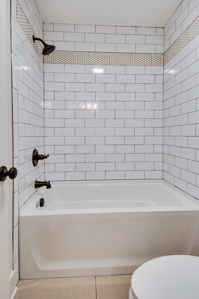 Inspiration for a medium sized country family bathroom in Nashville with shaker cabinets, dark wood cabinets, an alcove bath, a shower/bath combination, a two-piece toilet, white tiles, ceramic tiles, grey walls, ceramic flooring, a submerged sink, granite worktops, white floors and a shower curtain.