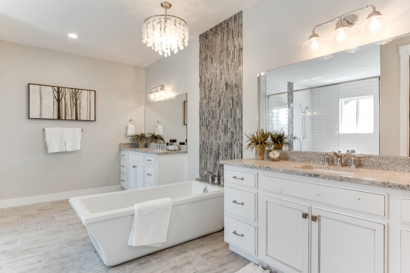 Inspiration for a large coastal ensuite bathroom in Salt Lake City with shaker cabinets, white cabinets, a freestanding bath, a double shower, a two-piece toilet, white tiles, ceramic tiles, grey walls, ceramic flooring, a submerged sink, granite worktops, beige floors and a hinged door.