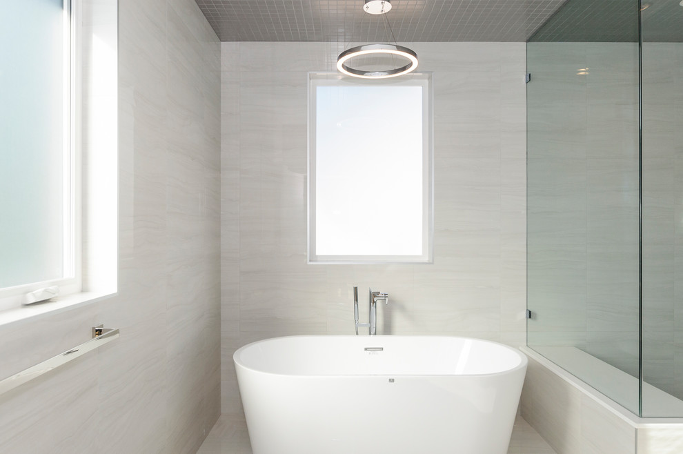Design ideas for a medium sized traditional ensuite bathroom in Vancouver with flat-panel cabinets, medium wood cabinets, a freestanding bath, a corner shower, a one-piece toilet, white tiles, porcelain tiles, white walls, porcelain flooring, a submerged sink, engineered stone worktops, white floors, a hinged door and white worktops.