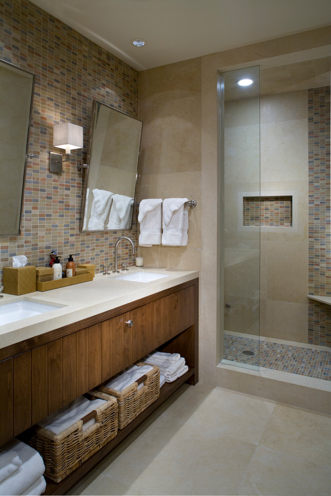 На фото: ванная комната в современном стиле с врезной раковиной, плоскими фасадами, темными деревянными фасадами, душем в нише, разноцветной плиткой и плиткой мозаикой