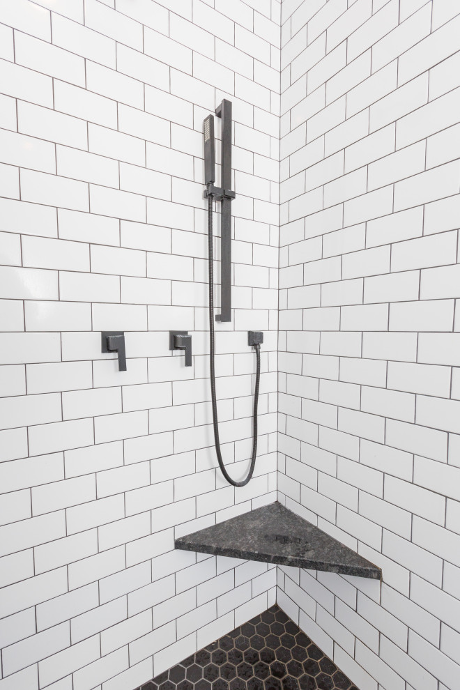 Inspiration for a medium sized classic ensuite bathroom in Cincinnati with freestanding cabinets, medium wood cabinets, a double shower, a wall mounted toilet, white tiles, grey walls, cement flooring, a trough sink, granite worktops, multi-coloured floors, an open shower, black worktops, an enclosed toilet, a single sink and a freestanding vanity unit.
