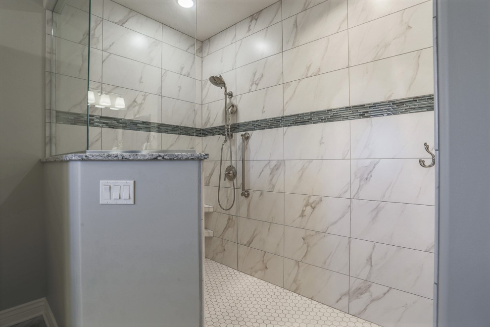 Design ideas for a large classic ensuite bathroom in Omaha with recessed-panel cabinets, blue cabinets, a built-in shower, a one-piece toilet, grey tiles, porcelain tiles, grey walls, porcelain flooring, a submerged sink, quartz worktops, grey floors, an open shower and multi-coloured worktops.