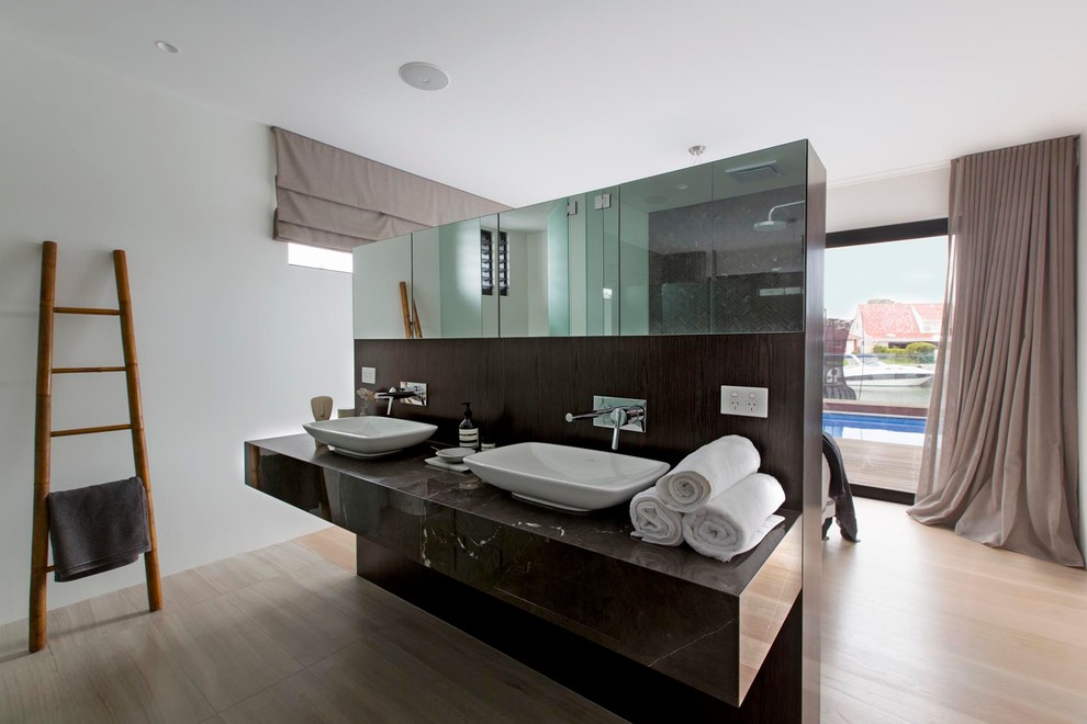 На фото: ванная комната в современном стиле с белыми стенами, светлым паркетным полом и настольной раковиной с