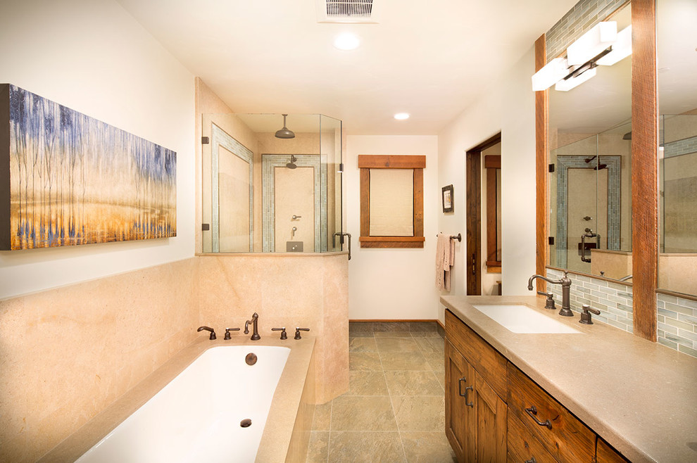 Photo of a medium sized rustic family bathroom in Other with shaker cabinets, medium wood cabinets, a corner bath, a corner shower, a two-piece toilet, multi-coloured tiles, porcelain tiles, beige walls, medium hardwood flooring, a submerged sink and limestone worktops.