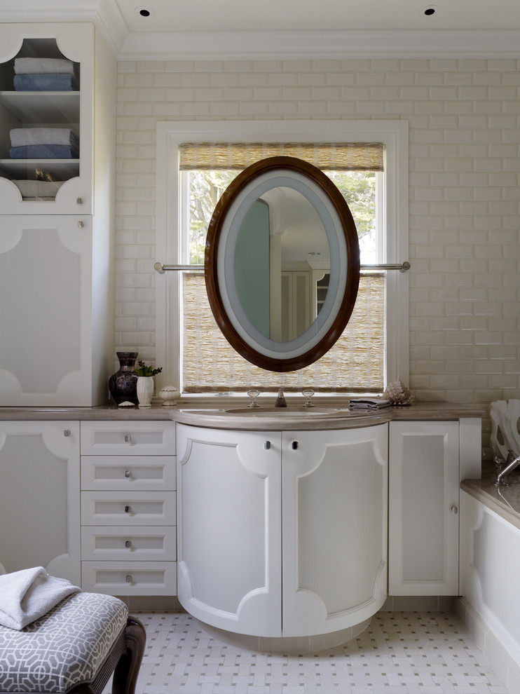 Trendy beige tile and subway tile bathroom photo in San Francisco with an undermount sink and white cabinets