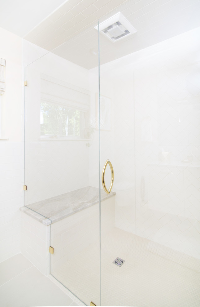 This is an example of a medium sized contemporary ensuite bathroom in Detroit with flat-panel cabinets, beige cabinets, a built-in shower, a wall mounted toilet, beige tiles, porcelain tiles, beige walls, porcelain flooring, a submerged sink, quartz worktops, beige floors, a hinged door and beige worktops.