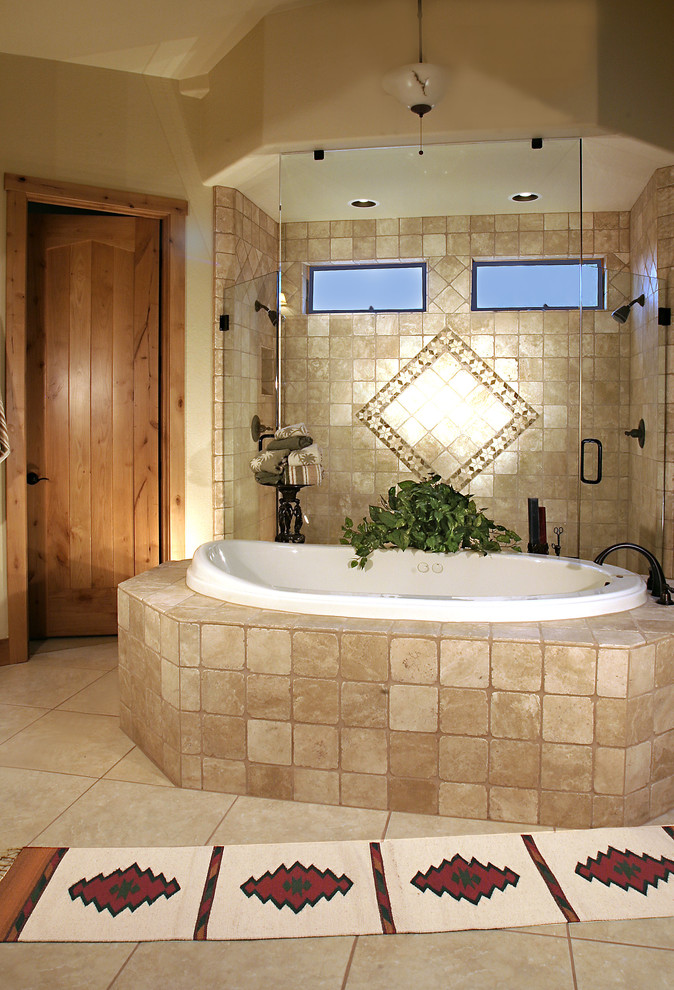 This is an example of an expansive ensuite bathroom in Phoenix with raised-panel cabinets, a submerged bath and a double shower.