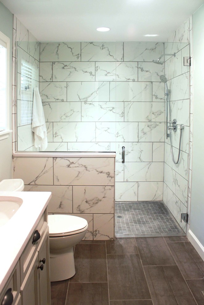Example of a mid-sized arts and crafts master white tile and ceramic tile ceramic tile walk-in shower design in Birmingham with shaker cabinets, gray cabinets, a one-piece toilet, blue walls, an undermount sink and quartzite countertops