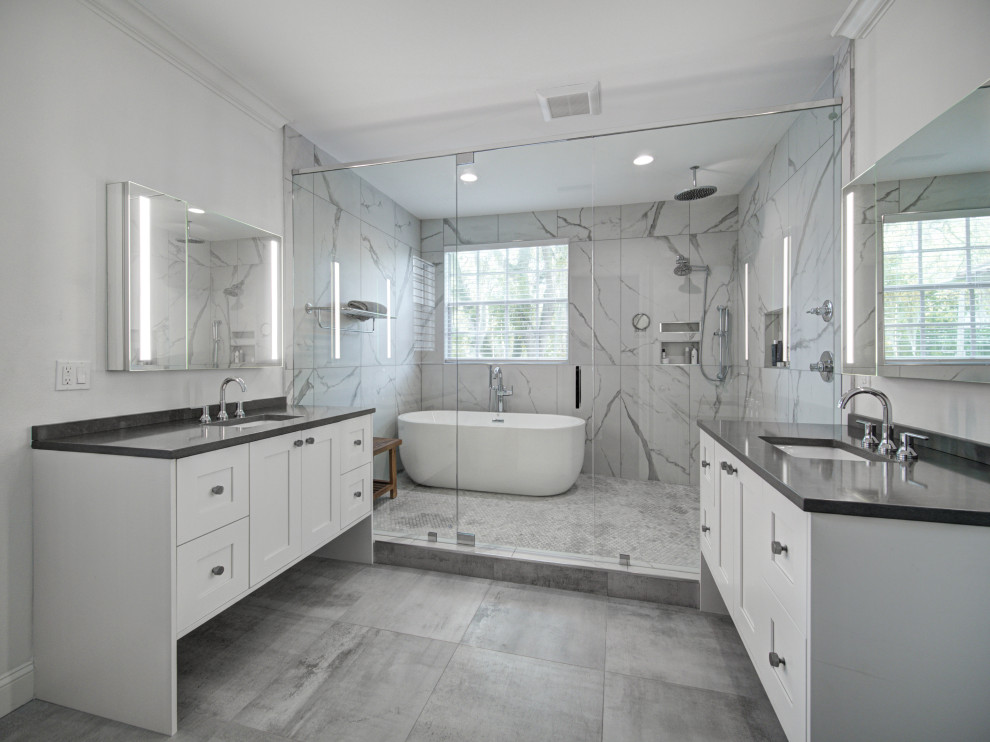 Bathroom - large contemporary master white tile and porcelain tile porcelain tile, gray floor and single-sink bathroom idea in Tampa with recessed-panel cabinets, white cabinets, white walls, an undermount sink, quartz countertops, a hinged shower door, gray countertops and a built-in vanity