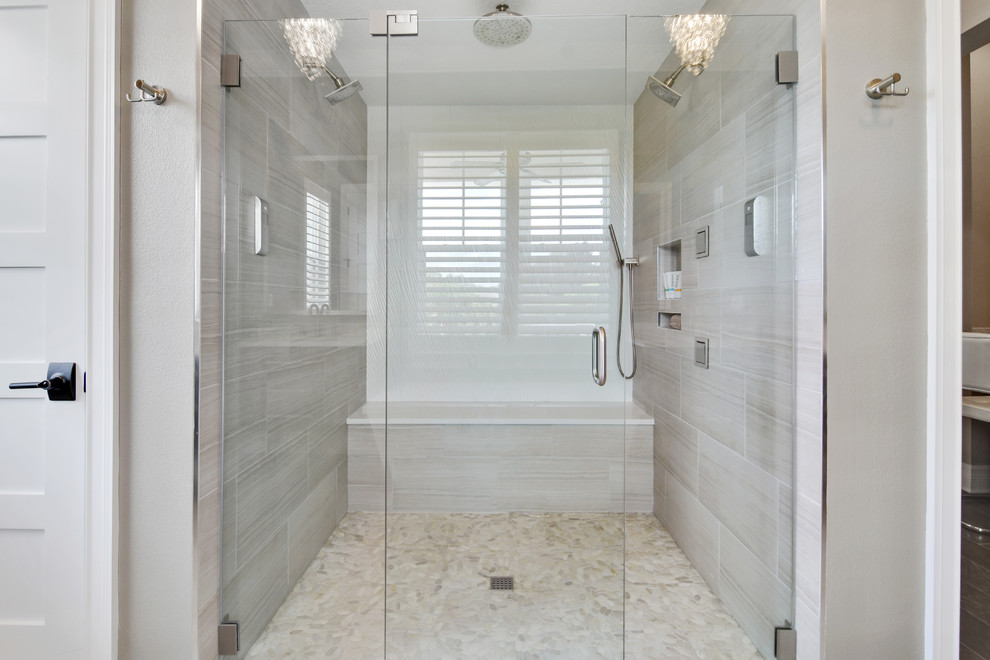 Inspiration for a large classic ensuite bathroom in Tampa with flat-panel cabinets, dark wood cabinets, a freestanding bath, an alcove shower, beige tiles, porcelain tiles, beige walls, porcelain flooring, a submerged sink, engineered stone worktops, beige floors and a hinged door.
