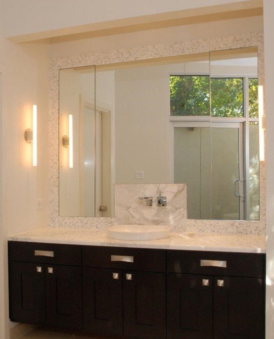 Example of a trendy master white tile limestone floor freestanding bathtub design in Houston with a vessel sink, shaker cabinets, dark wood cabinets, marble countertops and white walls
