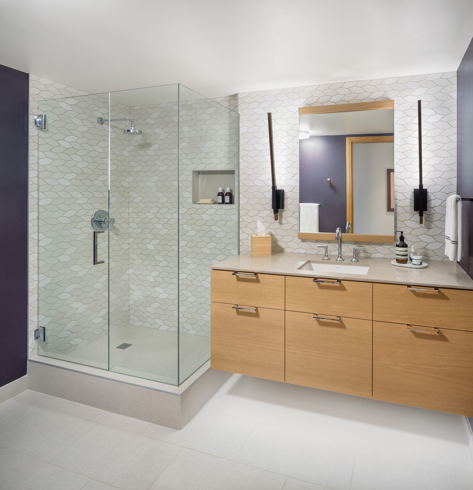 Example of a mid-sized trendy 3/4 beige tile and ceramic tile corner shower design in Portland with flat-panel cabinets, light wood cabinets, purple walls, an undermount sink and quartz countertops