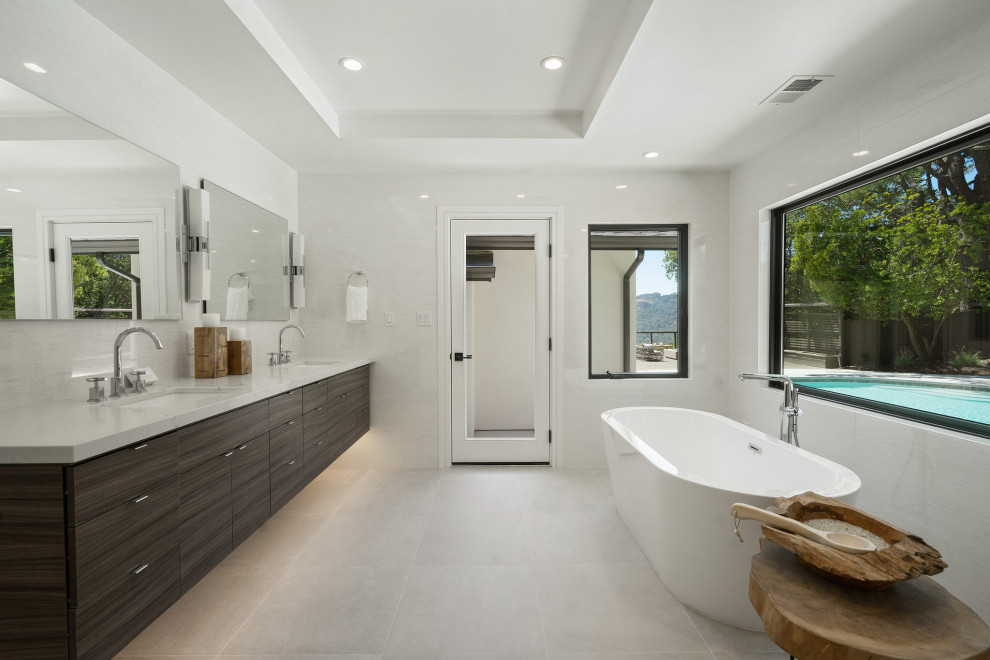 Inspiration for a contemporary master white floor and double-sink freestanding bathtub remodel in San Francisco with flat-panel cabinets, dark wood cabinets, white walls, an undermount sink, gray countertops and a floating vanity