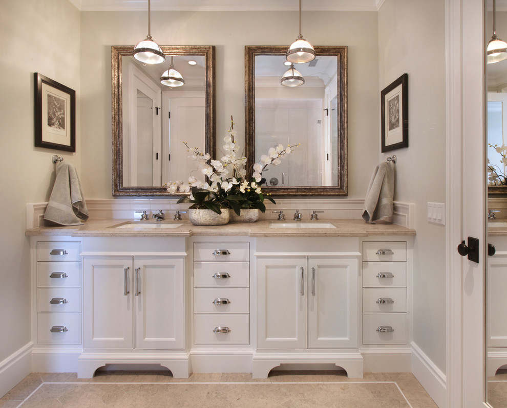 This is an example of a beach style bathroom in Orange County with white cabinets and beige walls.