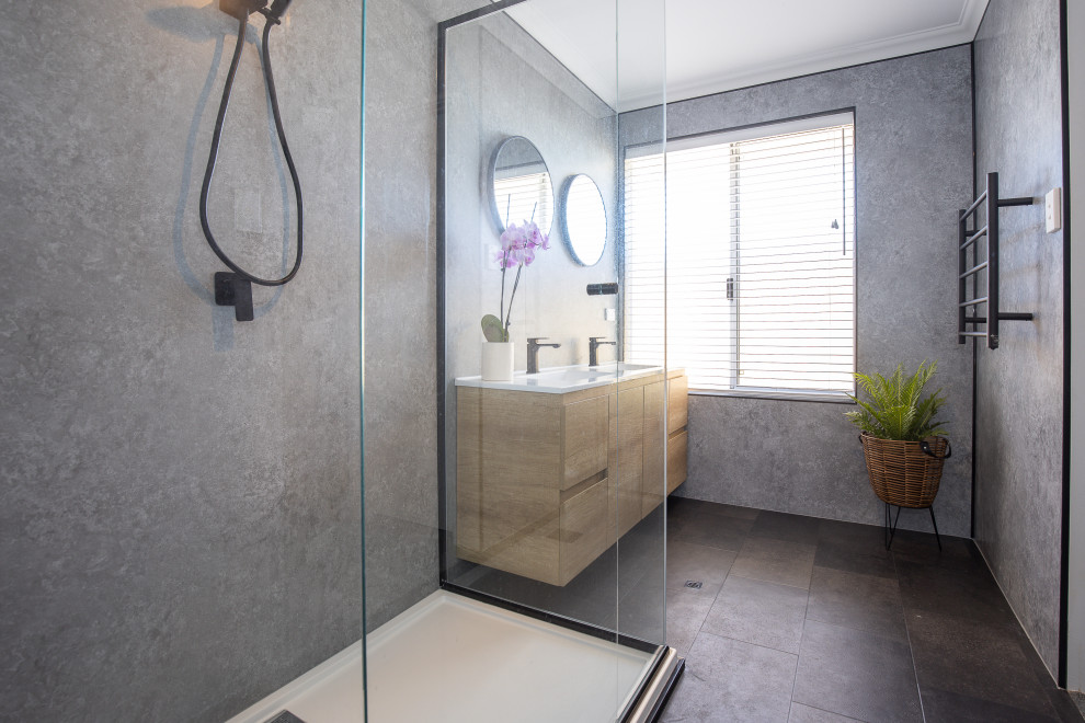 Inspiration for a medium sized modern ensuite bathroom in Perth with a corner shower, grey tiles, stone slabs, grey walls, vinyl flooring, engineered stone worktops, black floors, a hinged door and white worktops.