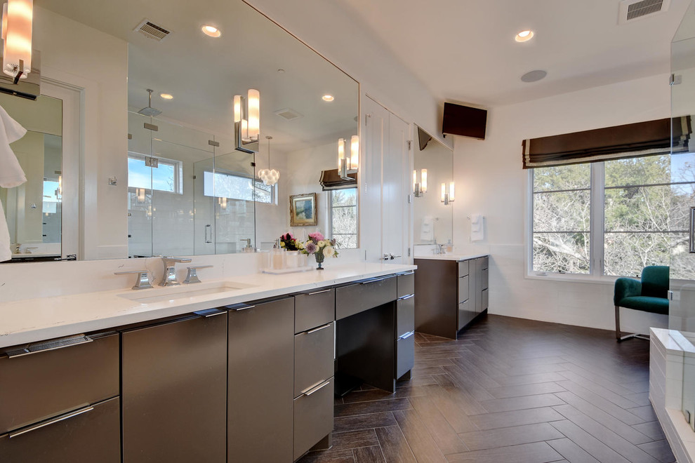 This is an example of a large contemporary ensuite bathroom in Austin with flat-panel cabinets, brown cabinets, white walls, dark hardwood flooring, a submerged sink, engineered stone worktops, brown floors, a hinged door, a freestanding bath, a corner shower, white tiles and porcelain tiles.