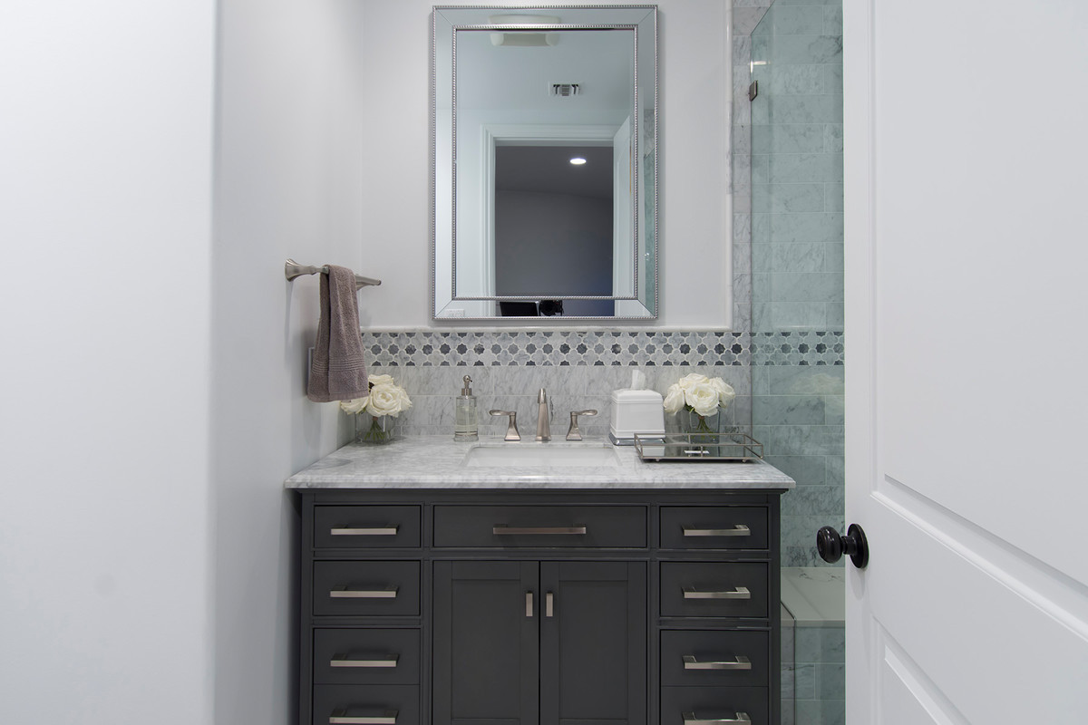 Small trendy 3/4 gray tile, white tile and marble tile marble floor and white floor alcove shower photo in Los Angeles with shaker cabinets, gray cabinets, white walls, an undermount sink, marble countertops and a hinged shower door