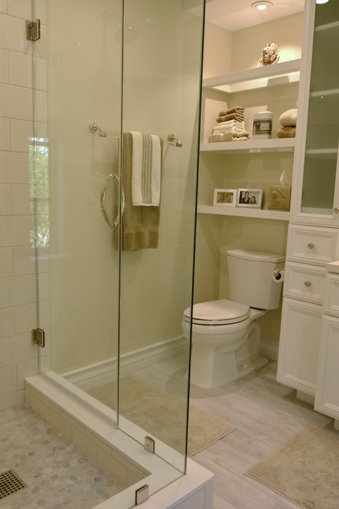 Medium sized traditional bathroom in Los Angeles with raised-panel cabinets, white cabinets, quartz worktops, a corner shower, a two-piece toilet, beige tiles, metro tiles and porcelain flooring.