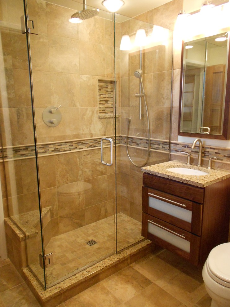 Example of a mid-sized transitional beige tile porcelain tile corner shower design in Denver with an undermount sink, glass-front cabinets, granite countertops, a two-piece toilet, beige walls and dark wood cabinets