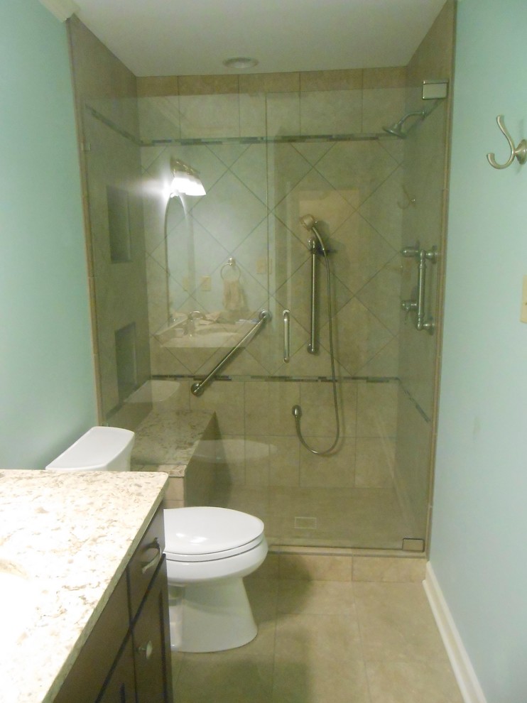 Example of a mid-sized transitional 3/4 beige tile and ceramic tile ceramic tile bathroom design in Other with an undermount sink, shaker cabinets, dark wood cabinets, a two-piece toilet, green walls and granite countertops