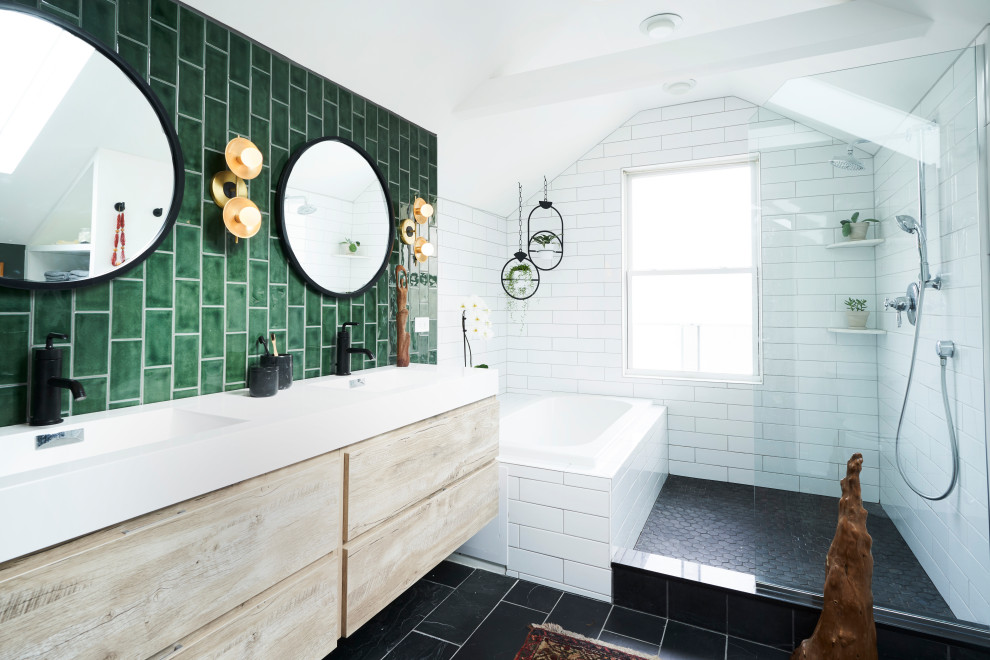 Inspiration for a medium sized contemporary ensuite bathroom in Chicago with flat-panel cabinets, light wood cabinets, a built-in bath, green tiles, ceramic tiles, slate flooring, an integrated sink, solid surface worktops, an open shower, white worktops, double sinks, a floating vanity unit, exposed beams, a vaulted ceiling and black floors.