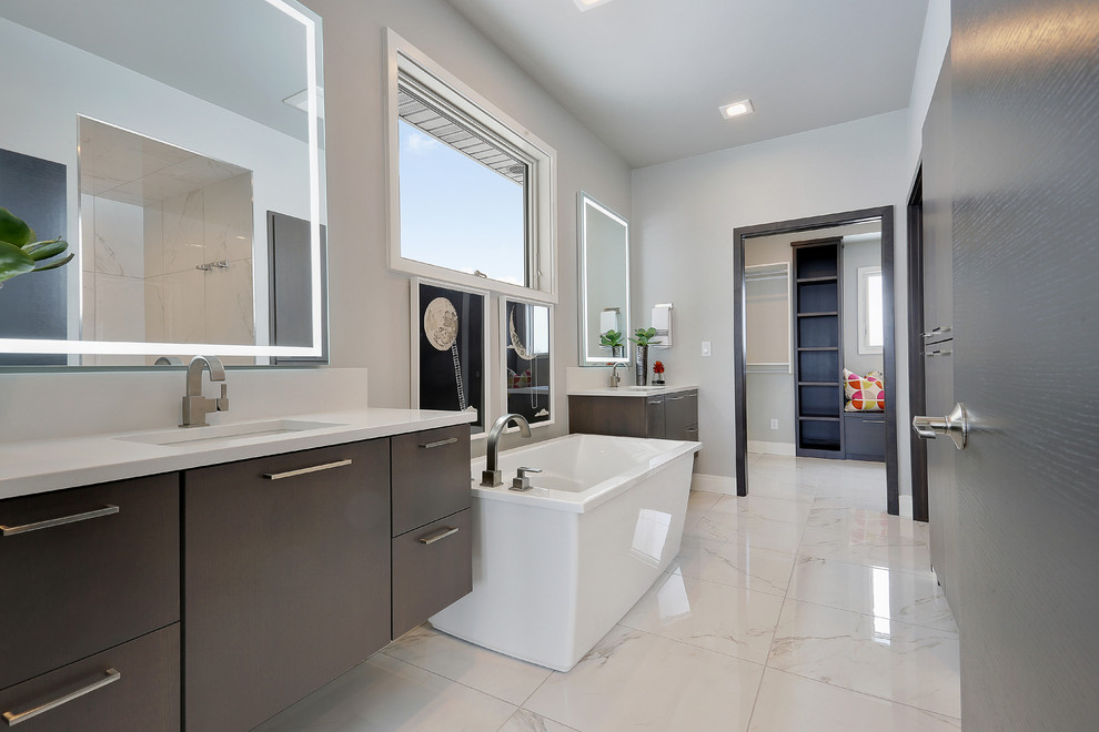 Bathroom - large contemporary master porcelain tile and white floor bathroom idea in Other with gray cabinets, a one-piece toilet, gray walls, an undermount sink, quartz countertops, white countertops and flat-panel cabinets