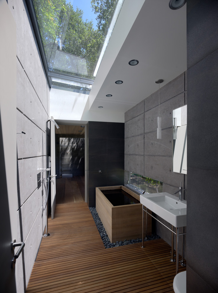Inspiration for a small modern medium tone wood floor bathroom remodel in San Francisco with a console sink