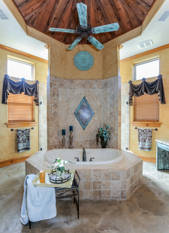 Large tuscan master beige tile and porcelain tile slate floor double shower photo in Houston with a drop-in sink, raised-panel cabinets, distressed cabinets, granite countertops, a hot tub, a bidet and yellow walls