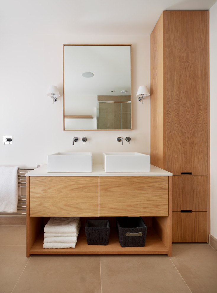 Ejemplo de cuarto de baño rectangular actual con lavabo sobreencimera, armarios con paneles lisos y puertas de armario de madera oscura