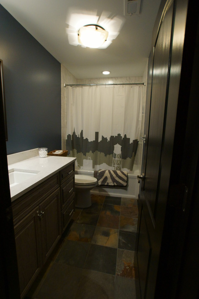 Example of a mid-sized classic white tile and ceramic tile slate floor bathroom design in Baltimore with an undermount sink, raised-panel cabinets, dark wood cabinets and blue walls