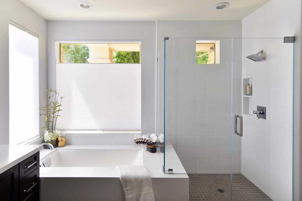 Design ideas for a medium sized classic ensuite bathroom in Phoenix with recessed-panel cabinets, black cabinets, a submerged bath, a corner shower, white tiles, ceramic tiles, grey walls, ceramic flooring, a submerged sink, engineered stone worktops, grey floors, a hinged door and white worktops.