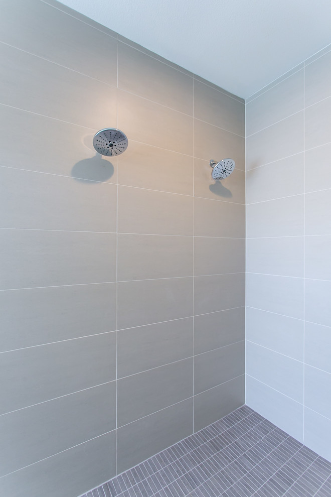 Example of a mid-sized minimalist master beige tile and porcelain tile porcelain tile and gray floor bathroom design in Seattle with flat-panel cabinets, light wood cabinets, a two-piece toilet, white walls, an undermount sink and quartz countertops