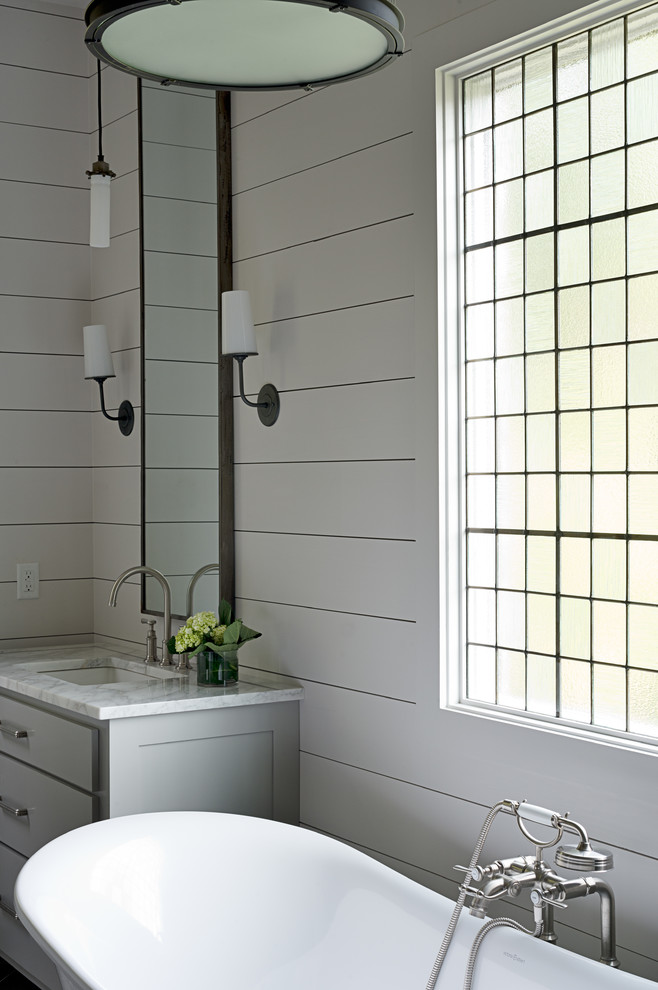 Inspiration for a mid-sized transitional master porcelain tile and gray floor freestanding bathtub remodel in Other with blue walls, flat-panel cabinets, gray cabinets, an undermount sink and marble countertops