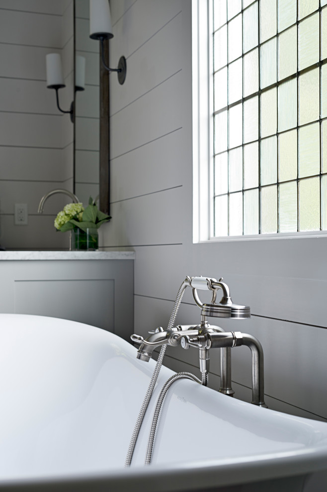 Freestanding bathtub - mid-sized transitional master porcelain tile and gray floor freestanding bathtub idea in Other with blue walls, flat-panel cabinets, gray cabinets, an undermount sink and marble countertops