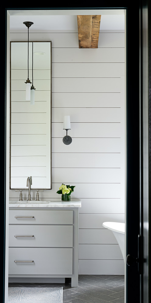 Example of a mid-sized transitional master porcelain tile and gray floor freestanding bathtub design in Other with blue walls, flat-panel cabinets, gray cabinets, an undermount sink and marble countertops
