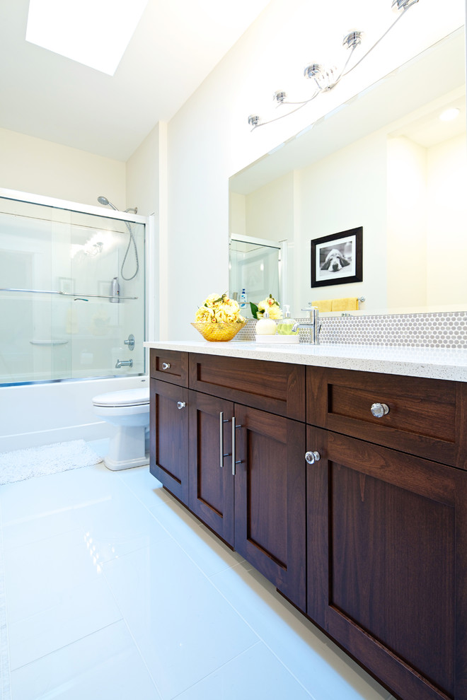 Design ideas for a medium sized classic family bathroom in Vancouver with shaker cabinets, dark wood cabinets, an alcove bath, a shower/bath combination, grey tiles, metal tiles, beige walls, marble flooring, a submerged sink and quartz worktops.