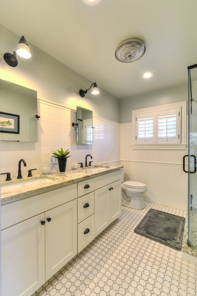 Inspiration for a small timeless master white tile and subway tile ceramic tile corner shower remodel in Austin with shaker cabinets, white cabinets, a two-piece toilet, gray walls, an undermount sink and granite countertops