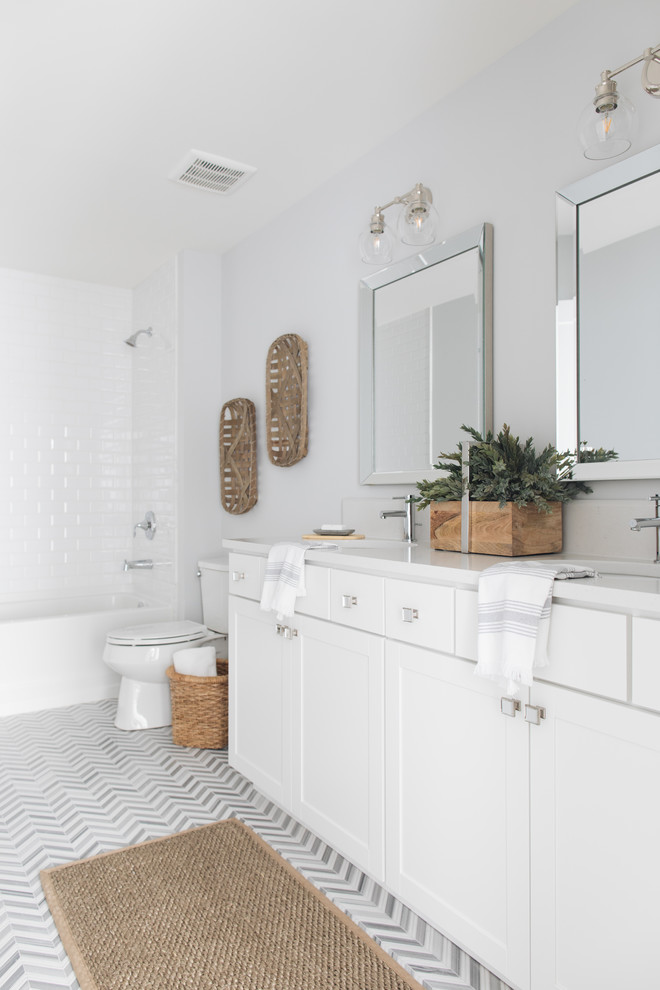 Inspiration for a cottage 3/4 white tile and subway tile gray floor bathroom remodel in Chicago with shaker cabinets, white cabinets, a two-piece toilet, gray walls and an undermount sink